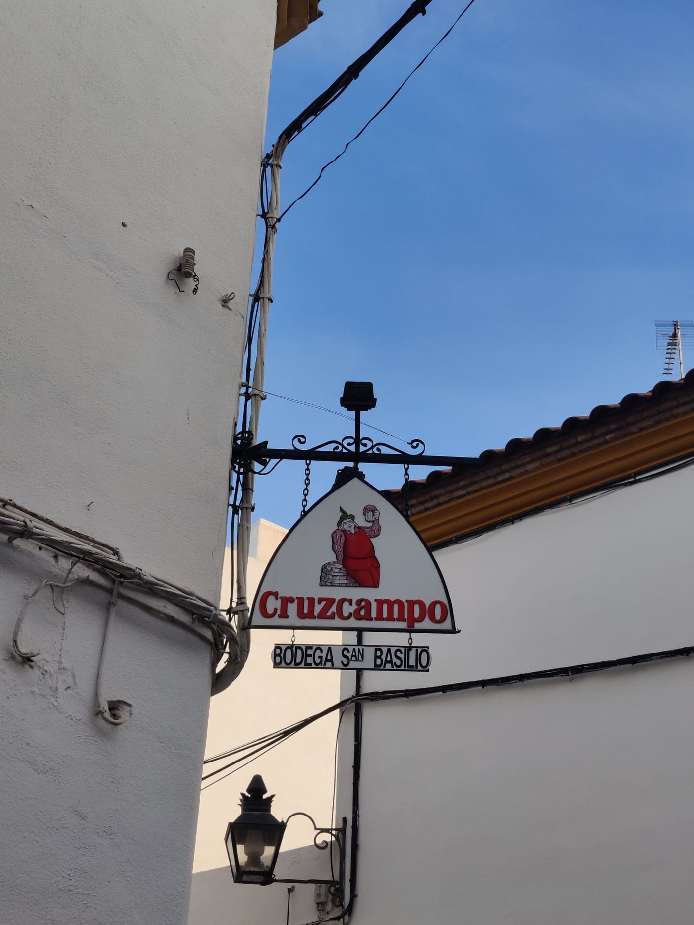 Bodega San Basilio sign against a blue sky